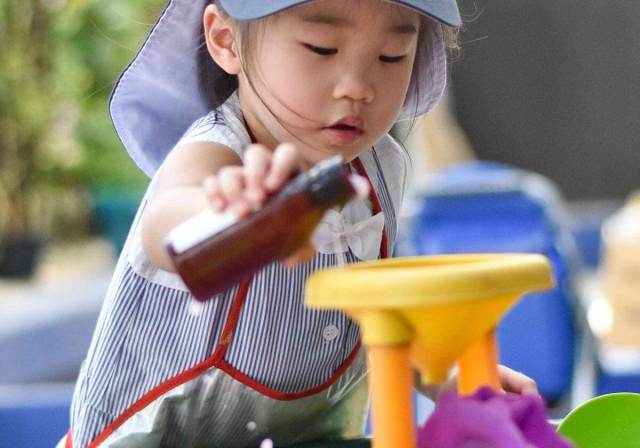 GIRL PLAYING WITH WATER
