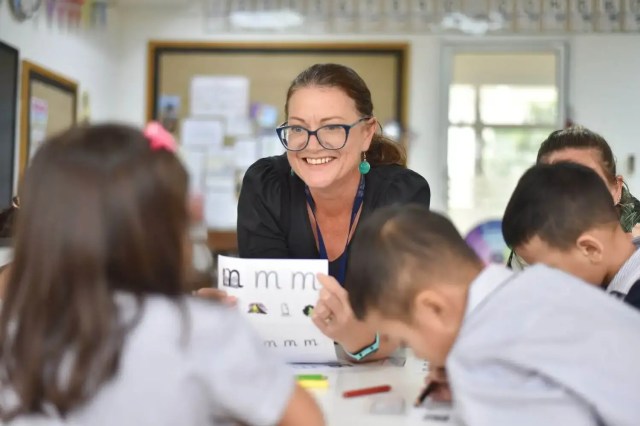 teacher-helping-students-close-up