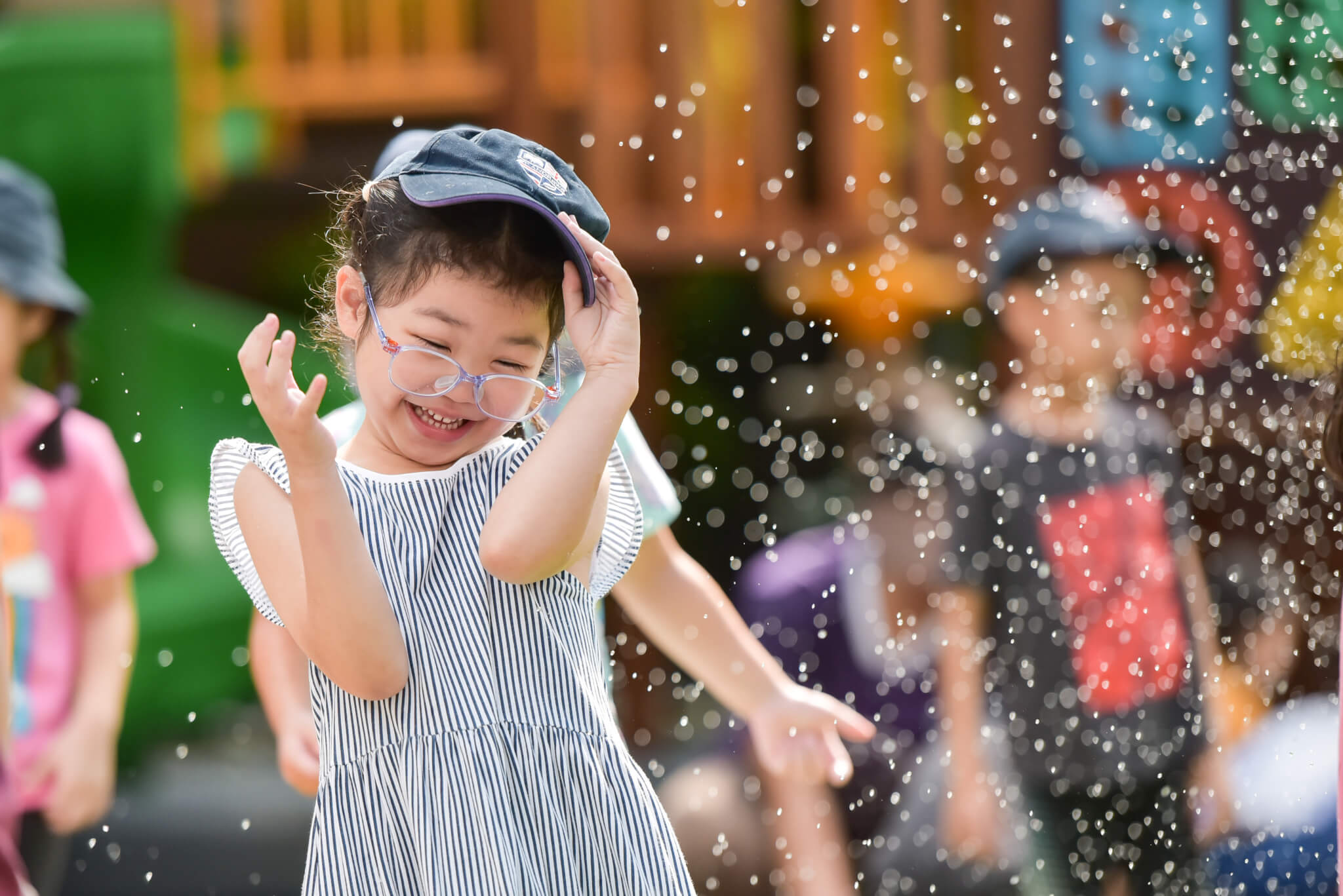 Early Years child enjoying water play at St Andrews Dusit