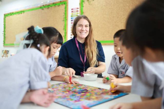 Primary students collaborating on a classroom learning activity at St Andrews Dusit