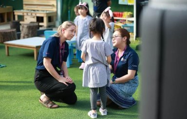 Reception Teacher – St Andrews Dusit Reception teacher supporting a young student at St Andrews Dusit